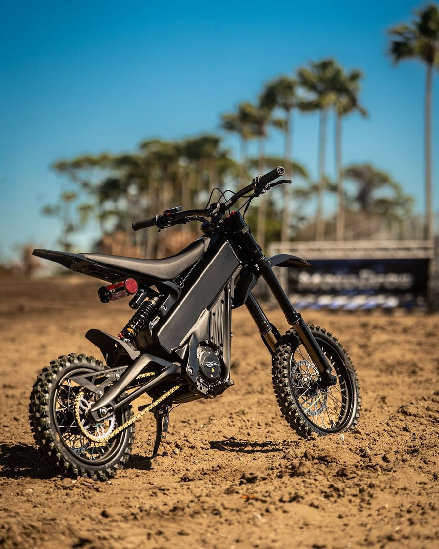 Talaria X3 Mini on a dirt track — front three-quarter view