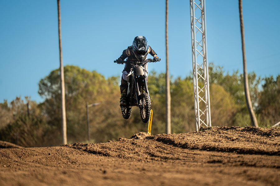 Talaria X3 Mini jumping on a motocross track