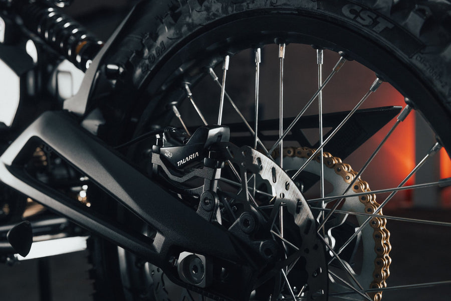 Talaria X3 Pro — rear wheel, chain and swingarm close-up