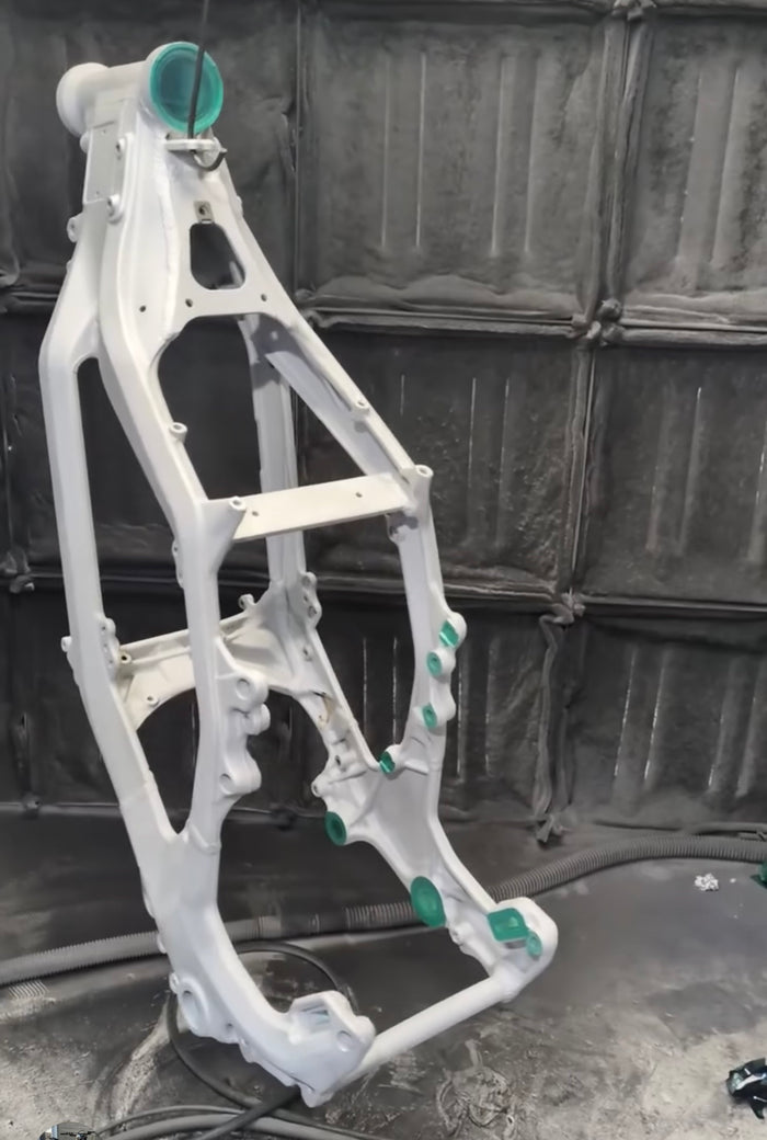 Frame masked with plugs over the bearing bores and threads