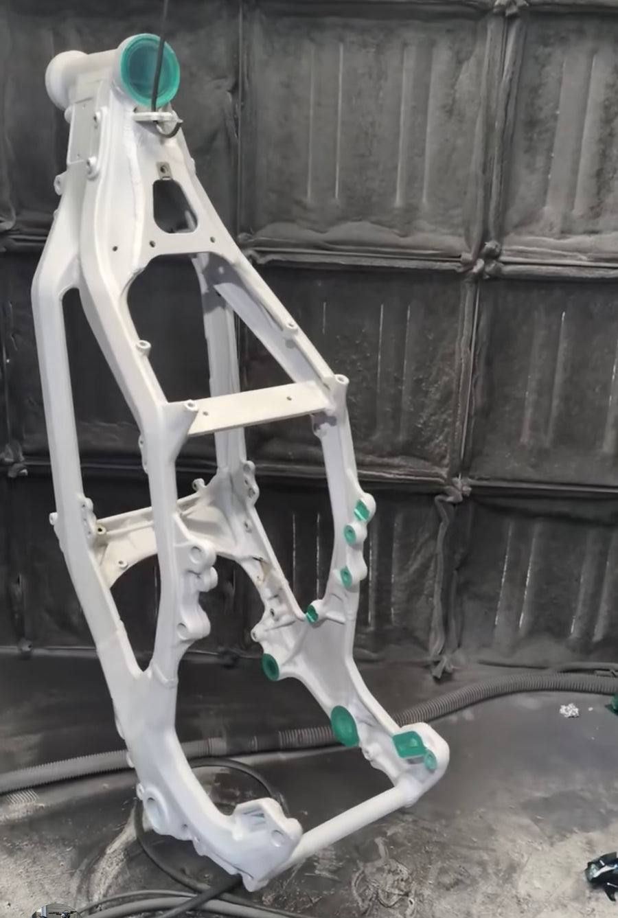 Frame masked with plugs over the bearing bores and threads